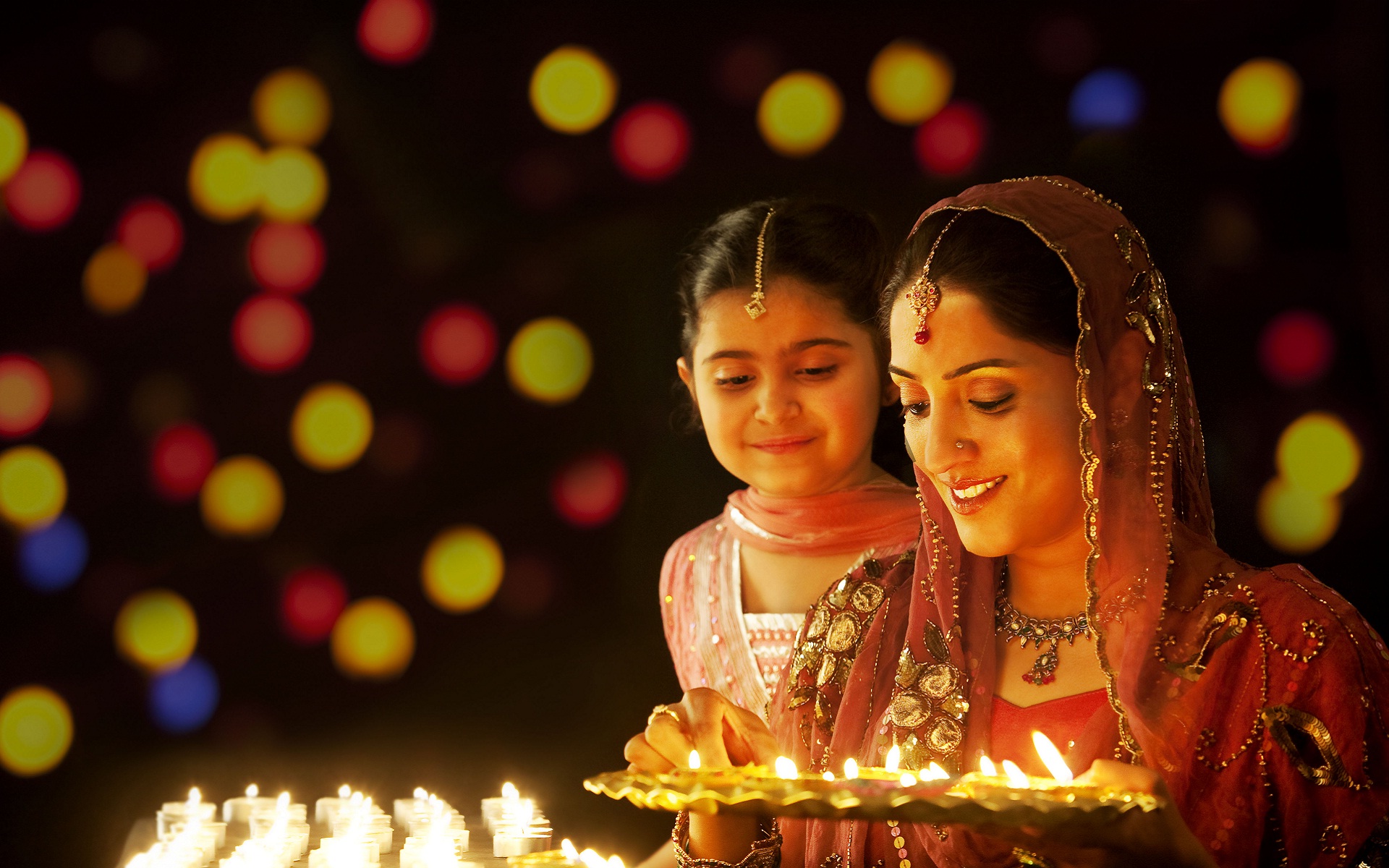 happy diwali indian woman lighting diya