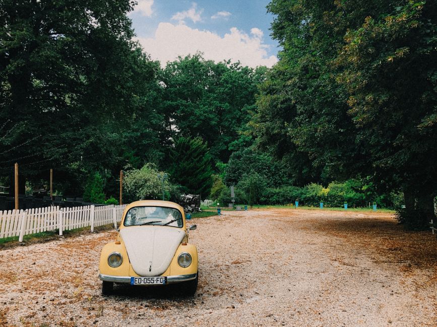 A rental car driving on a scenic road in the French countryside