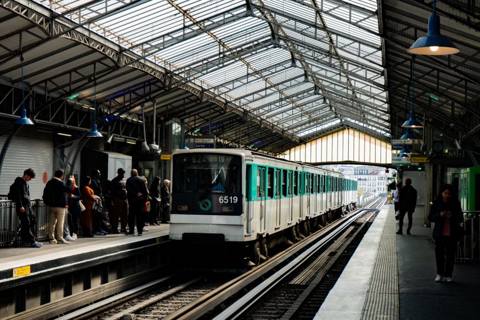 Travelers at a Paris metro station, symbolizing transport costs in France