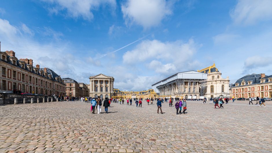 Grand exterior of the Palace of Versailles on a sunny day, a popular day trip from Paris