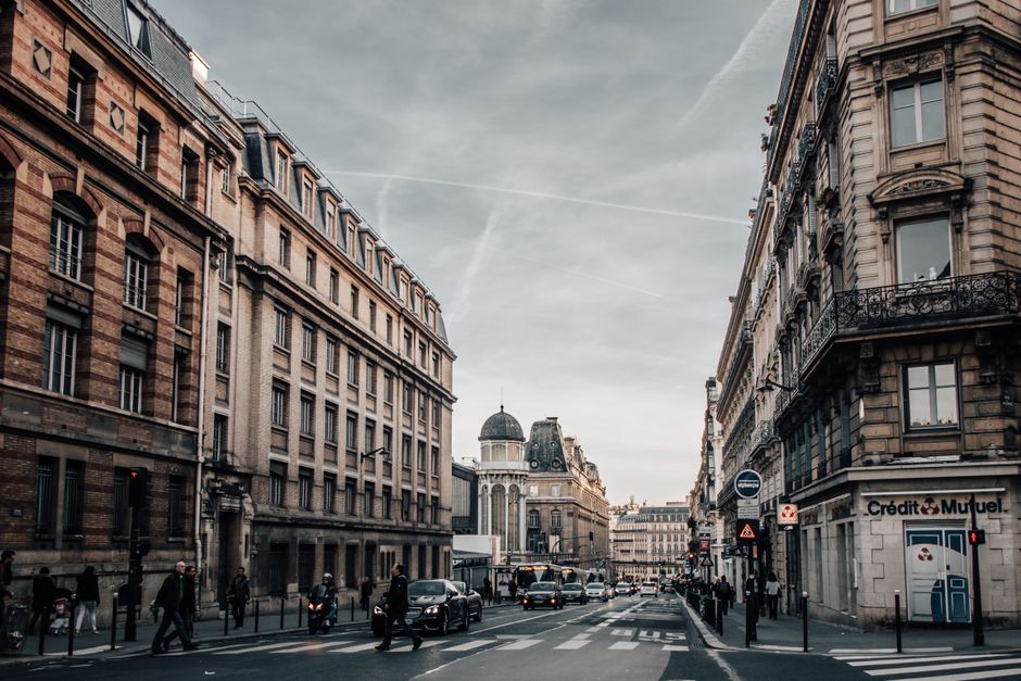 French police officer on patrol in a Paris street, symbolizing safety and security for travelers.