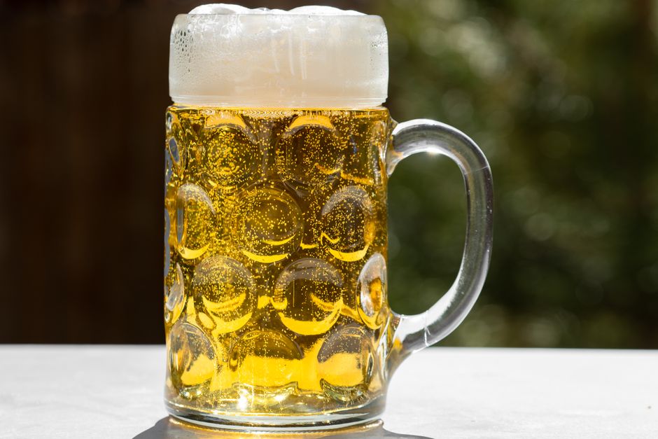 People enjoying traditional German food and beer in a lively beer garden