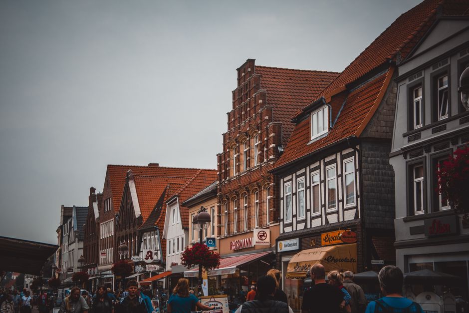 Busy shopping street in a German city with people carrying shopping bags