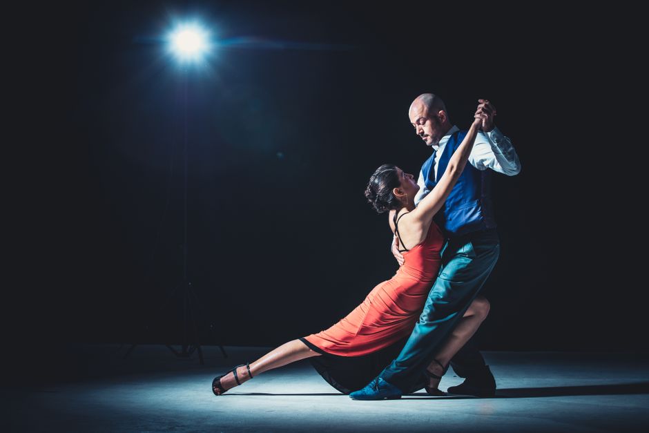 Couple dancing tango passionately in a traditional milonga in Buenos Aires, Argentina