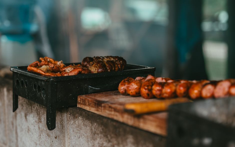 A vibrant Argentine parrillada (mixed grill) with various cuts of meat, sausages, and vegetables on a table in Buenos Aires.