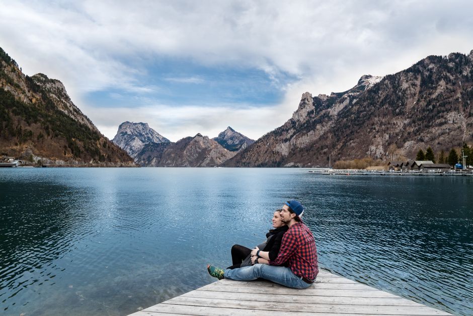 A traveler enjoying a scenic view of the Austrian Alps, symbolizing peace of mind with Austria travel insurance
