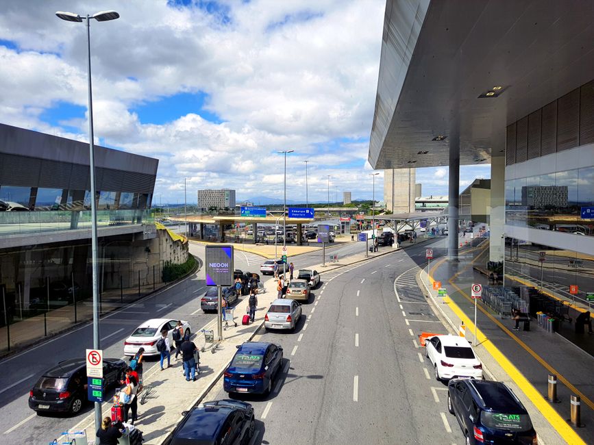 Tourist picking up rental car keys at a counter in Brazil