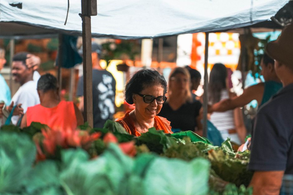 A vibrant street market in Brazil with fresh produce and local food stalls, showcasing the cost of living.