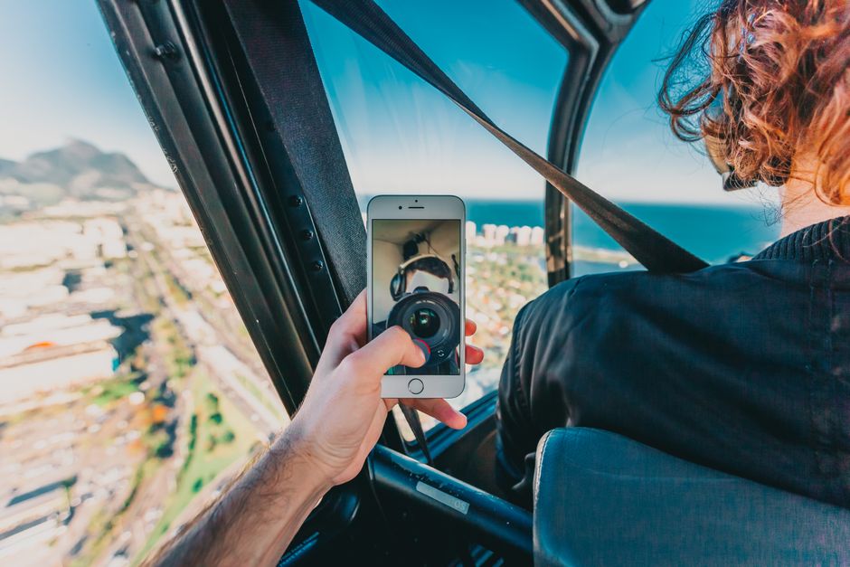 Traveler using a smartphone to navigate in Rio de Janeiro, Brazil, with a vibrant city background