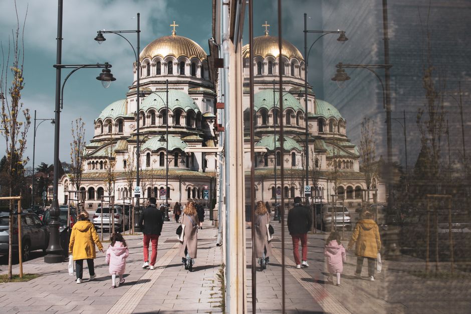 Vibrant street scene in Sofia, Bulgaria, with people enjoying the city life and historic architecture.
