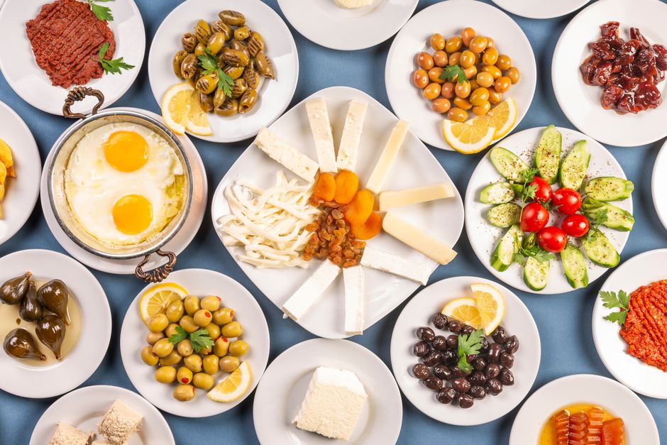 A vibrant spread of traditional Bulgarian food, including Shopska Salata, banitsa, and various grilled meats, set on a rustic table in Bulgaria.