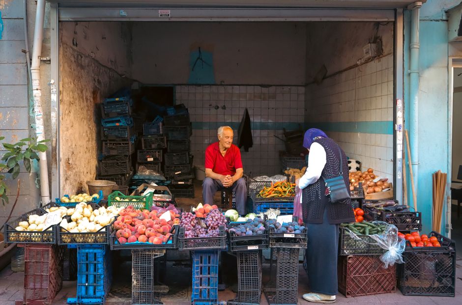 A vibrant traditional market scene in Bulgaria with various local products and people shopping