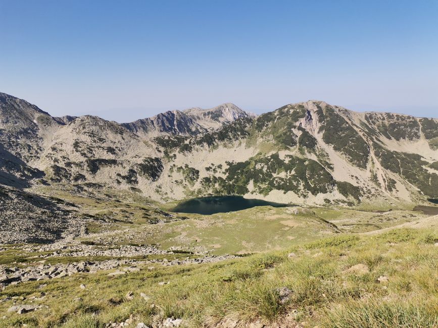 Traveler enjoying a panoramic view of the Rila Mountains in Bulgaria, symbolizing a worry-free trip with travel insurance