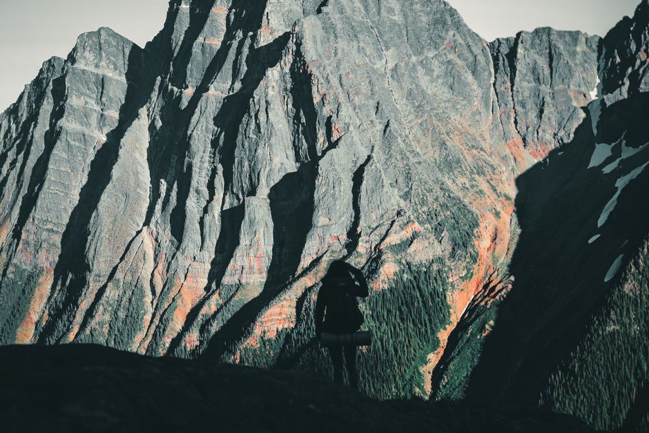 Traveler studying a map with the stunning Canadian Rockies in the background