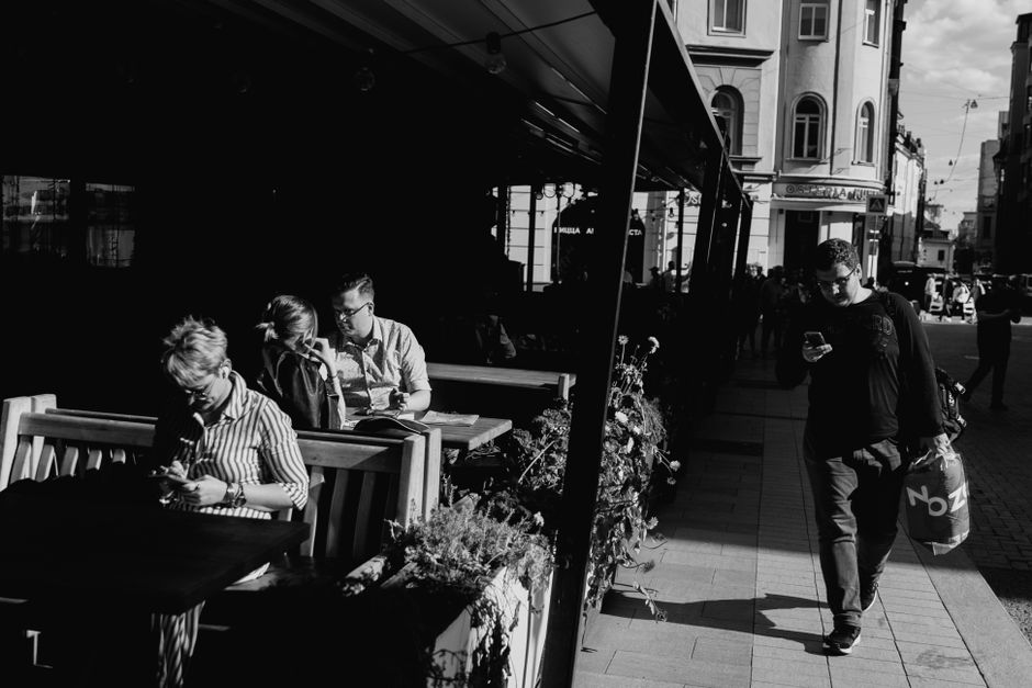 People enjoying coffee at a lively street cafe in Croatia, showing typical daily life.