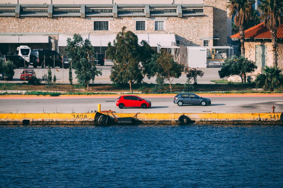 Car driving on a scenic coastal road in Cyprus with blue sea