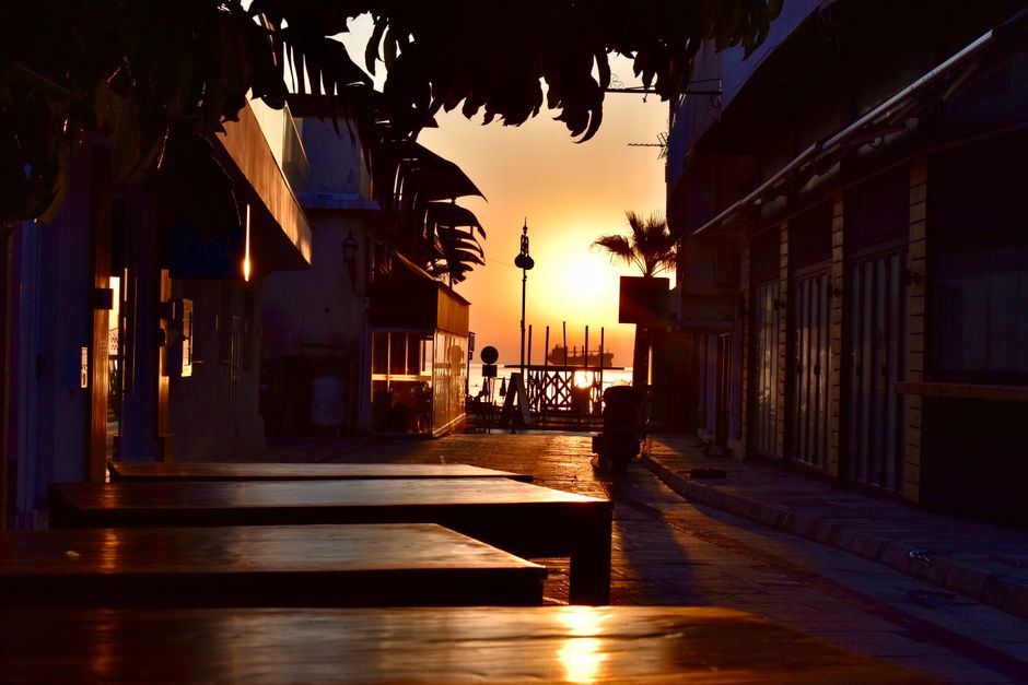 Tourists walking on a sunny street in Cyprus, illustrating travel and daily life