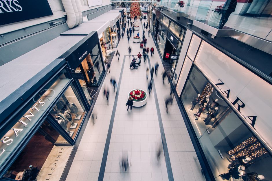 People shopping at a modern mall in Cyprus with bright storefronts