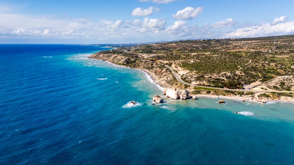 Golden sandy beach in Cyprus under clear blue sky, representing sunny weather