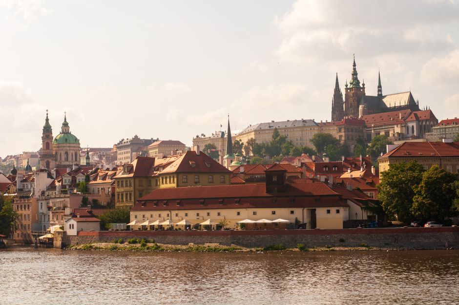 Panoramic view of Prague Castle and Charles Bridge at sunrise