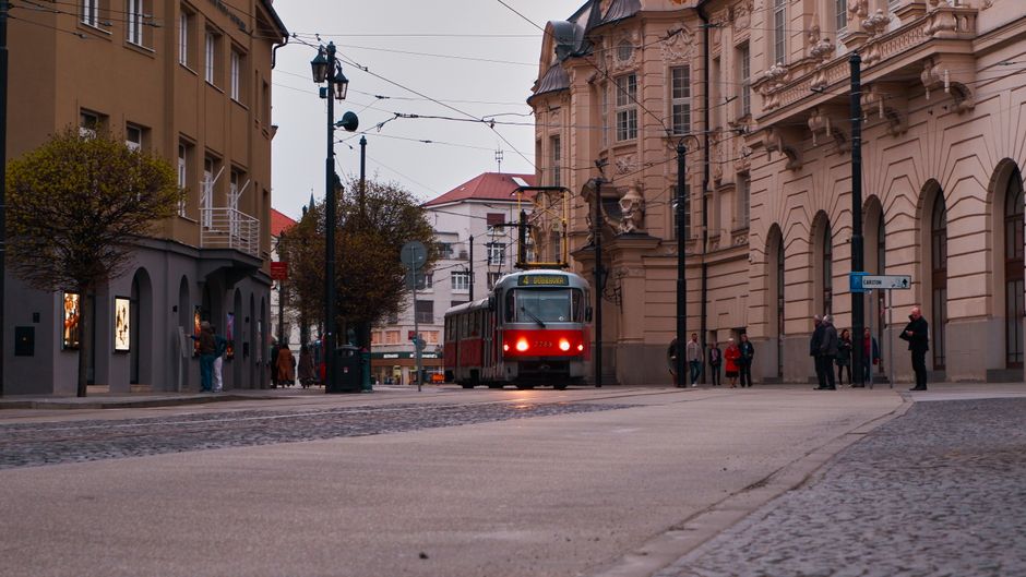 Red tram in Prague city center with historic buildings