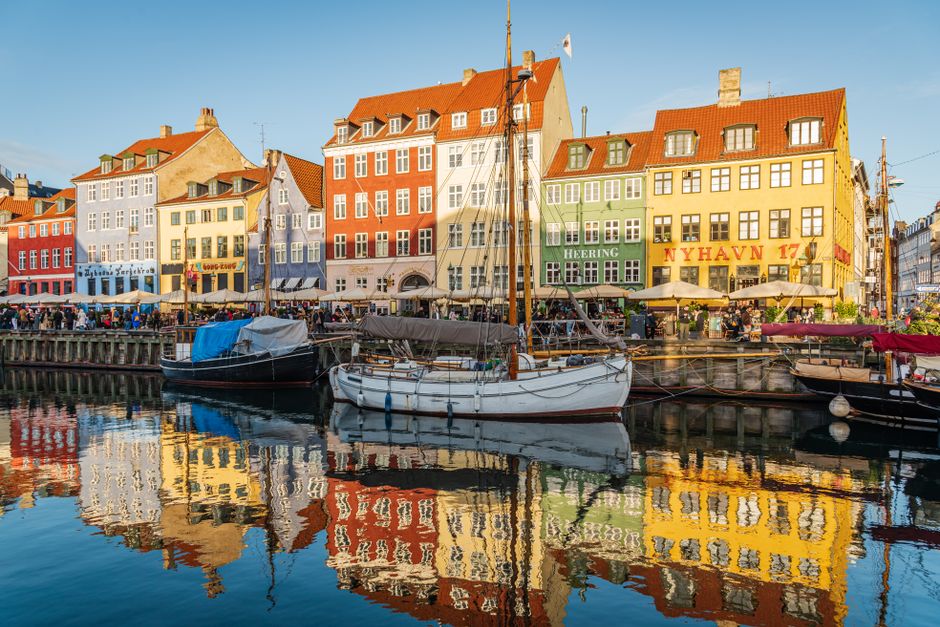 Colorful buildings along the Nyhavn canal in Copenhagen, Denmark, with boats