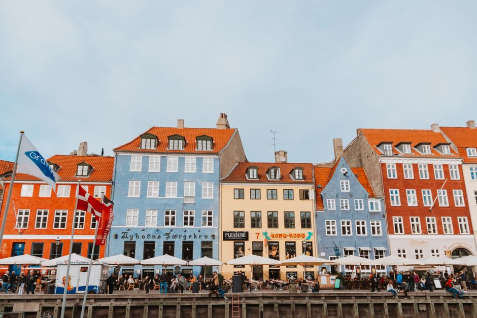 Colorful buildings along a canal in Copenhagen, Denmark, reflecting the vibrant travel experience