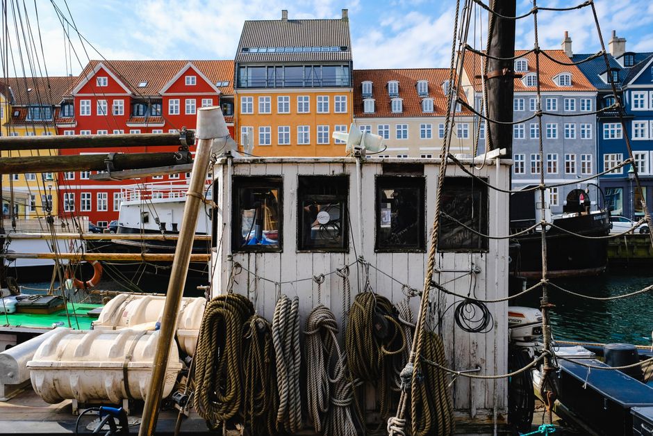 Colorful buildings along Nyhavn canal in Copenhagen, Denmark, reflecting in the water