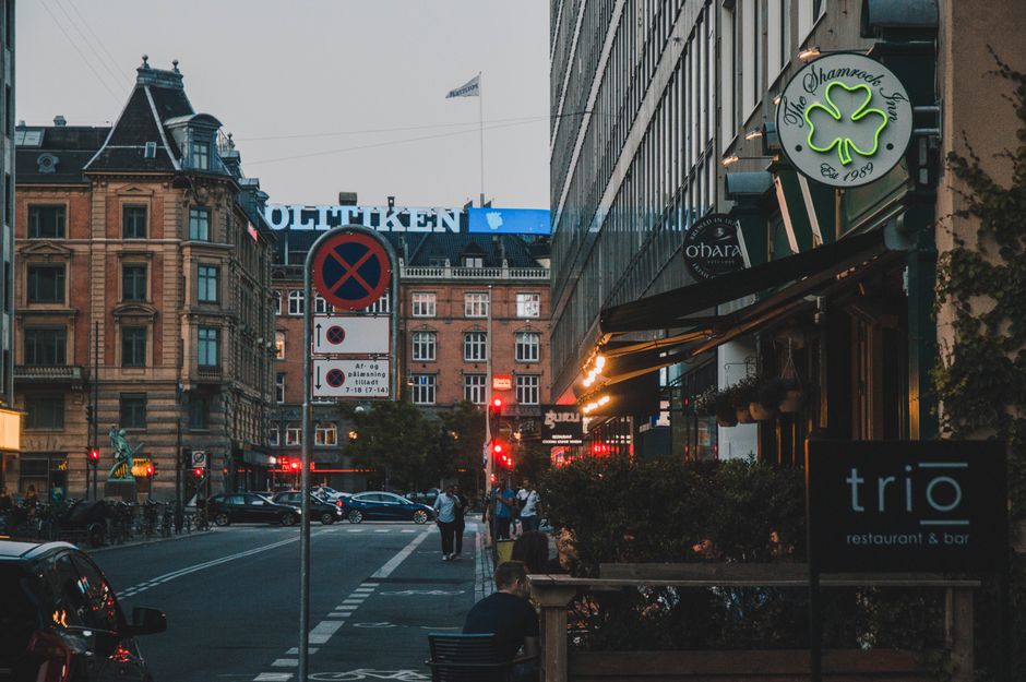 Tourist using a smartphone in a vibrant Copenhagen street in Denmark