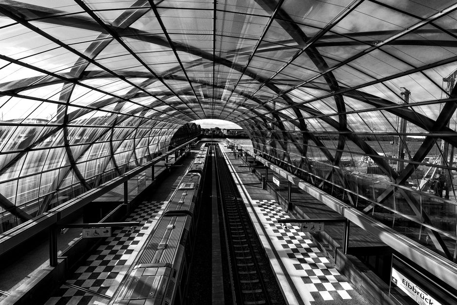 Modern train platform at Copenhagen Airport, Denmark, with a train arriving