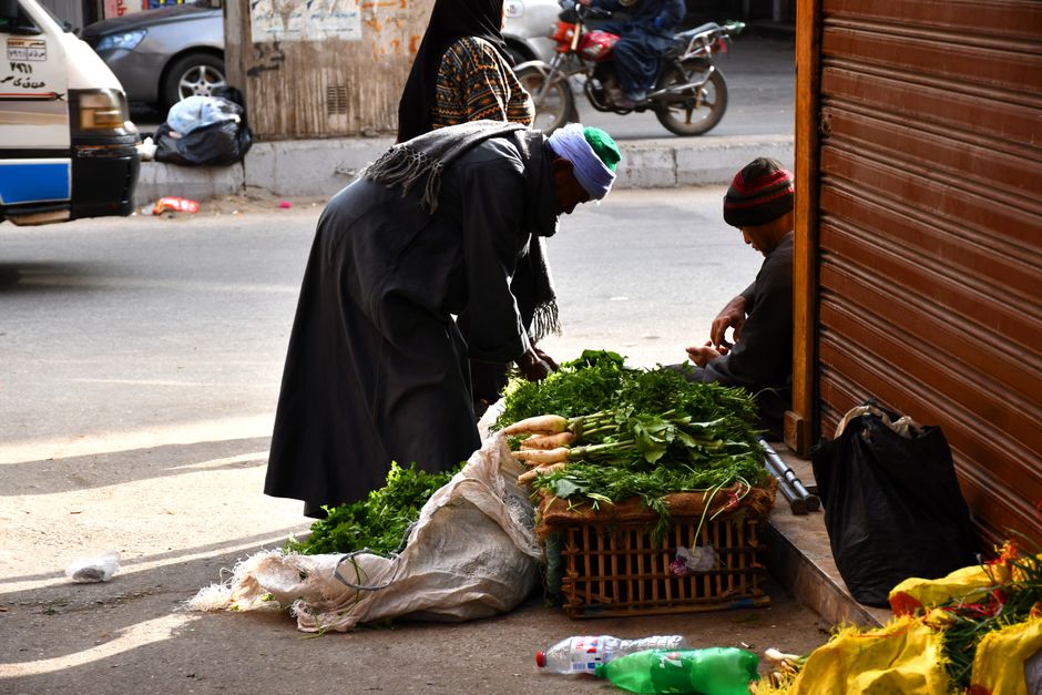 Vibrant market scene in Egypt with local goods and people, illustrating cost of living