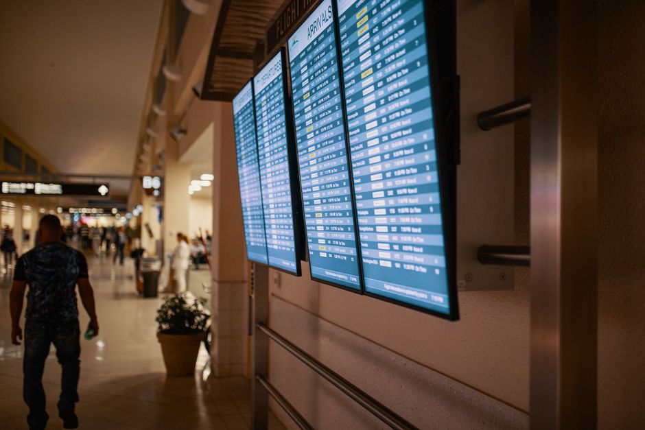 Departure board showing delayed flights at Cairo International Airport, Egypt