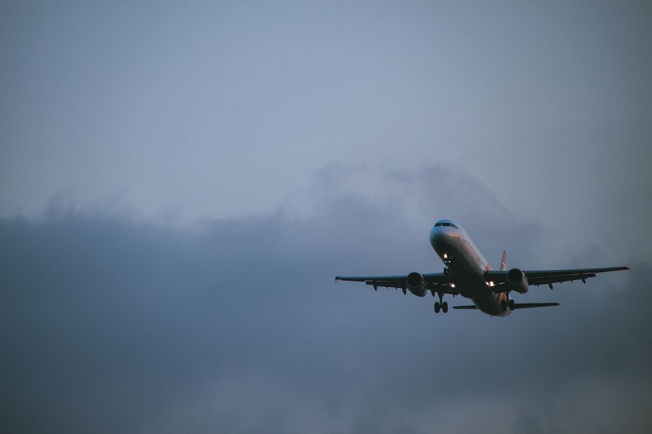 EgyptAir plane taking off from Cairo International Airport with pyramids in the distance
