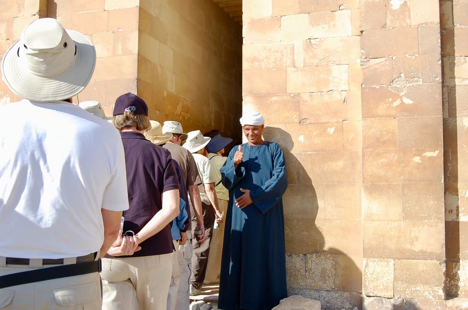 Tourists admiring the Great Pyramids of Giza and the Sphinx in Egypt