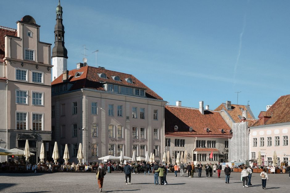 Group on a walking tour in Tallinn Old Town, Estonia, with historic buildings