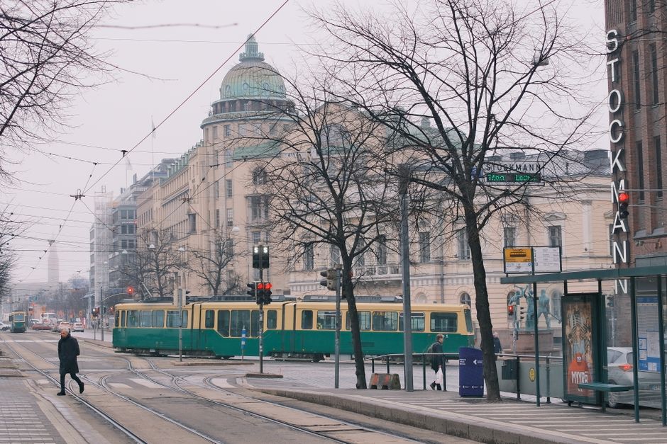 A bustling shopping street in Helsinki, Finland, with people browsing stores