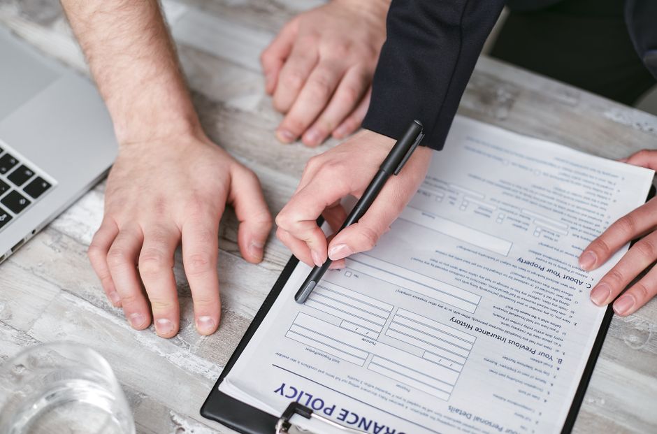 Travel insurance documents spread on a table with a map of Finland, symbolizing secure travel planning.