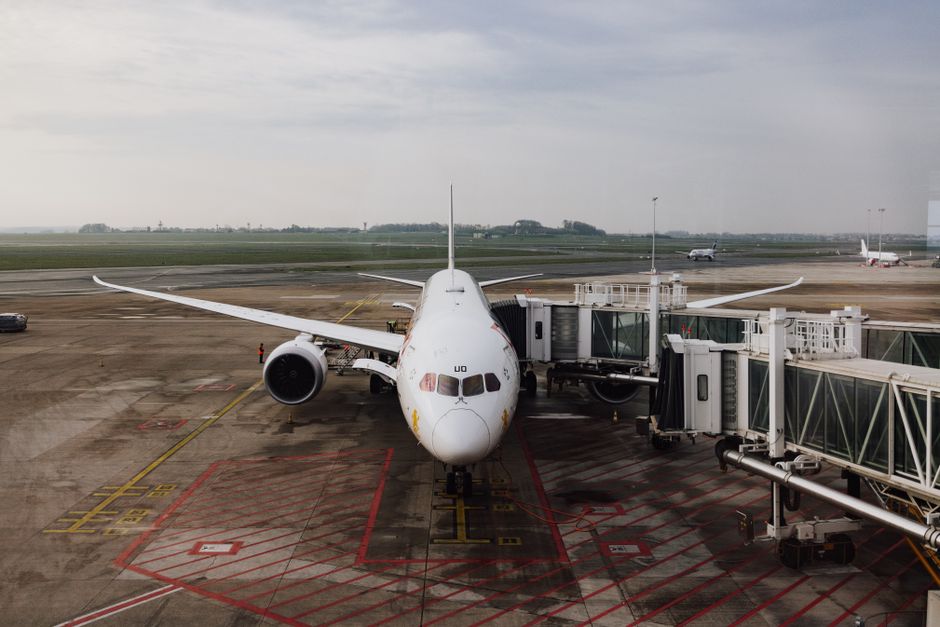 Travelers in a busy departure lounge at a major UK airport