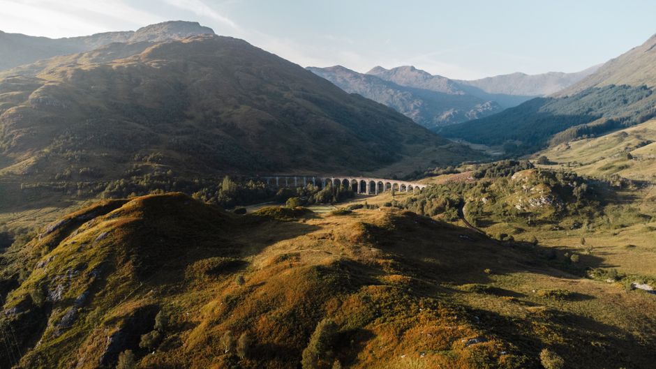 A train travels through the picturesque British countryside on a day trip in Great Britain.