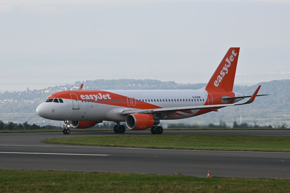 Passengers waiting in a busy airport terminal due to a delayed flight in Great Britain
