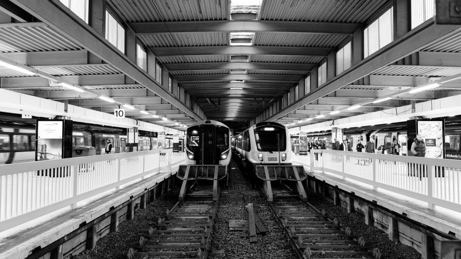 Busy London transport hub with trains and people