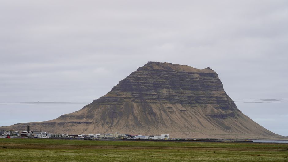 Stunning Icelandic landscape with a traveler, symbolizing budget-friendly exploration