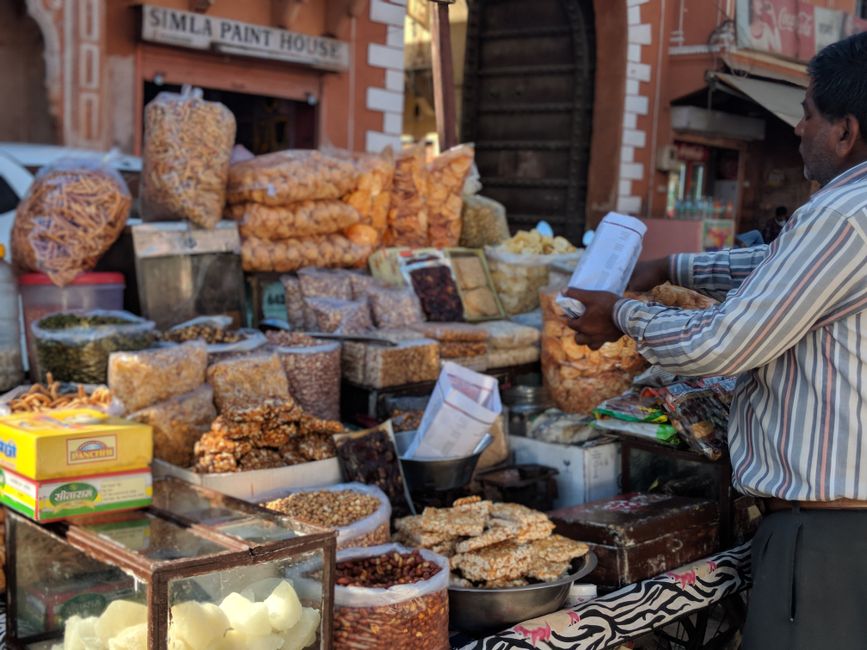 Vibrant street market scene in India with colorful textiles and local people