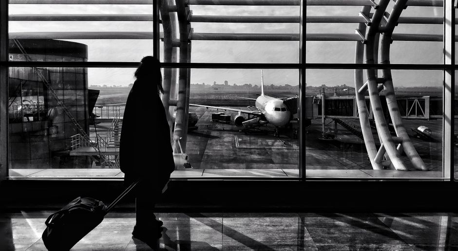 Passengers at a busy airport terminal in India, representing flight travel and potential disruptions