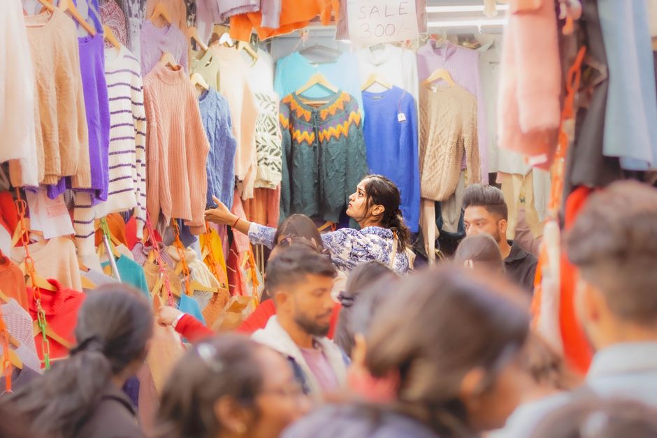 A bustling street market in India with colorful textiles and local vendors