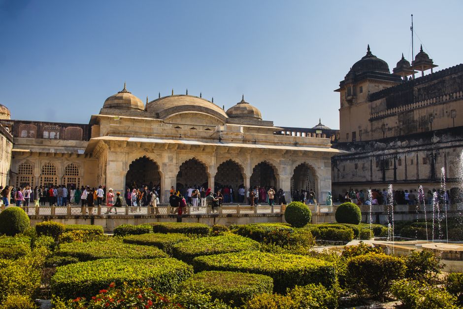 Tourists exploring a historical monument in India, part of a Golden Triangle tour