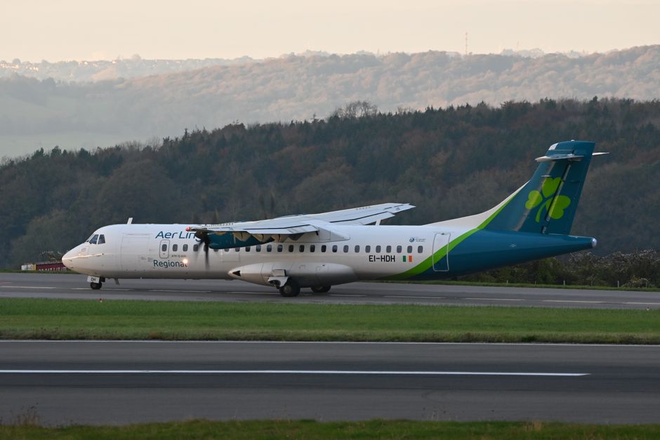 An airplane landing at Dublin Airport in Ireland with a view of the city in the background