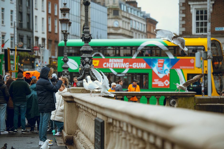 Traveler using a smartphone in a vibrant street in Dublin, Ireland