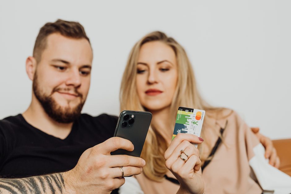 Traveler holding an Ireland SIM card with a scenic Irish landscape in the background