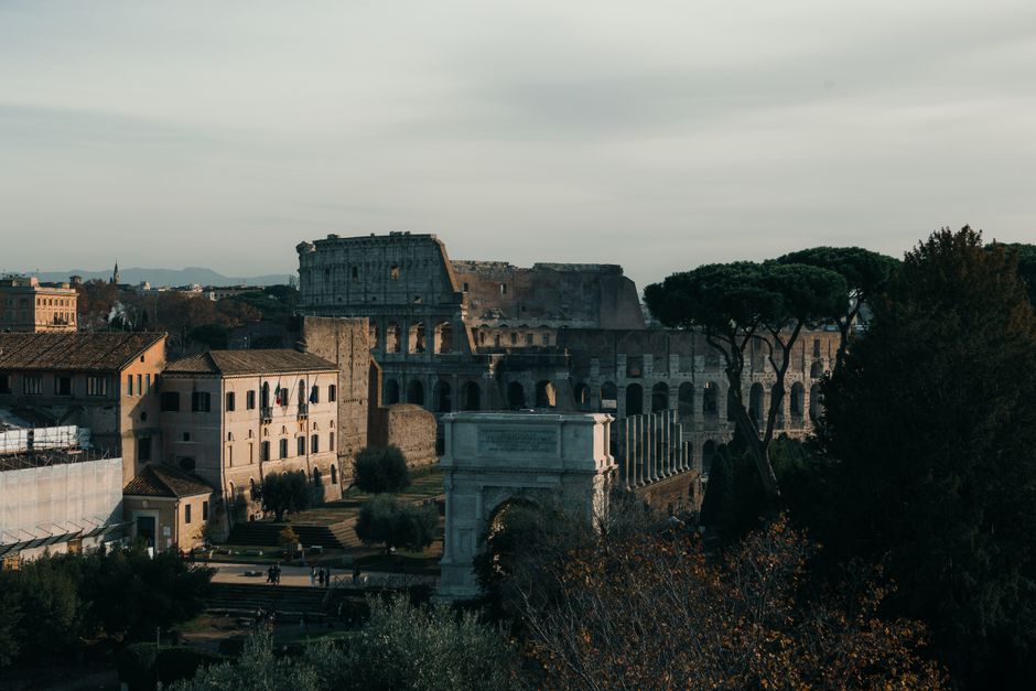 Panoramic view of historic Rome, Italy, with ancient ruins at sunset